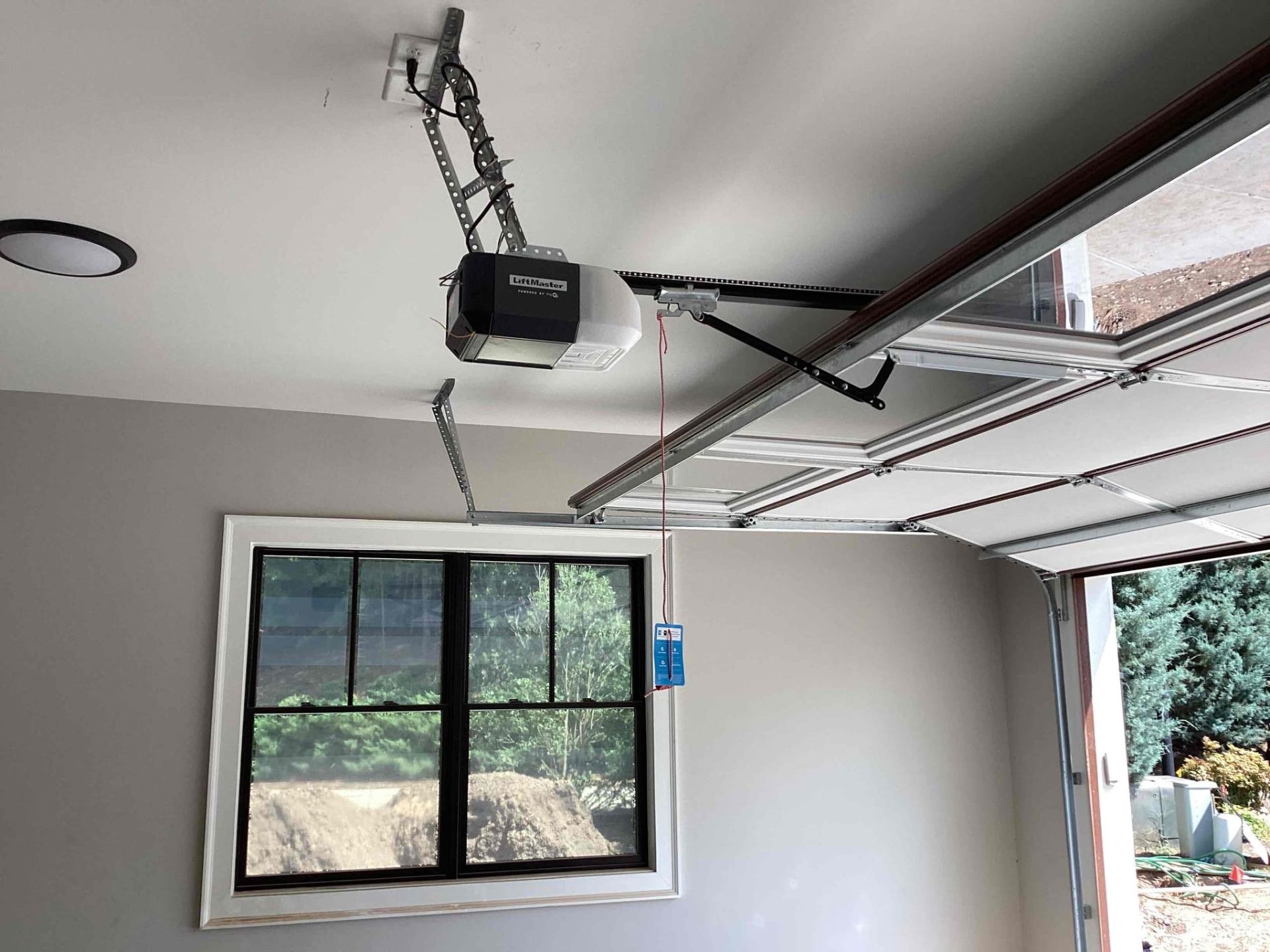 Garage door opener maintenance and inspection by a professional technician